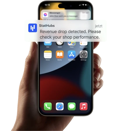 Smartphone in Hand; Banner mit StatHubs-Logo und Text: Revenue drop detected. Please check your shop performance.